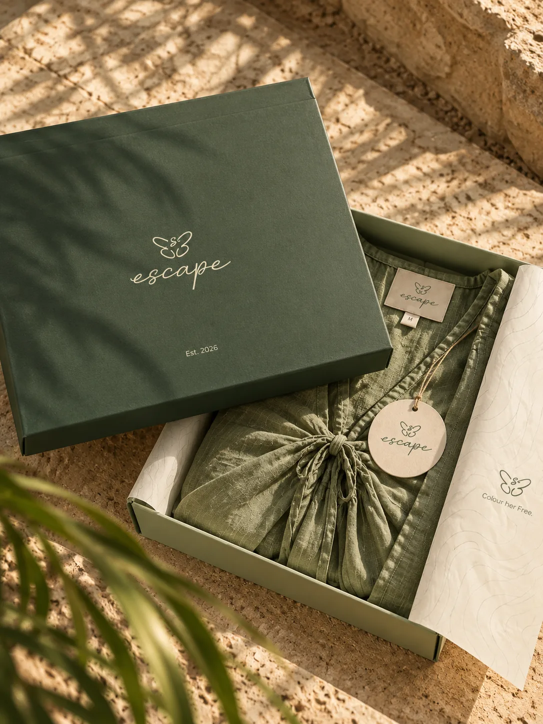 Deep green Escape gift box with sage garment, label and round tag